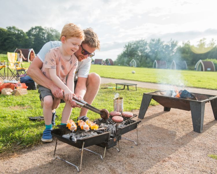 Father and son cooking on a bbq