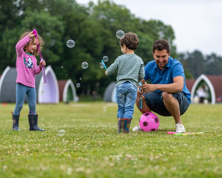 Kids playing with bubbles on a camping site