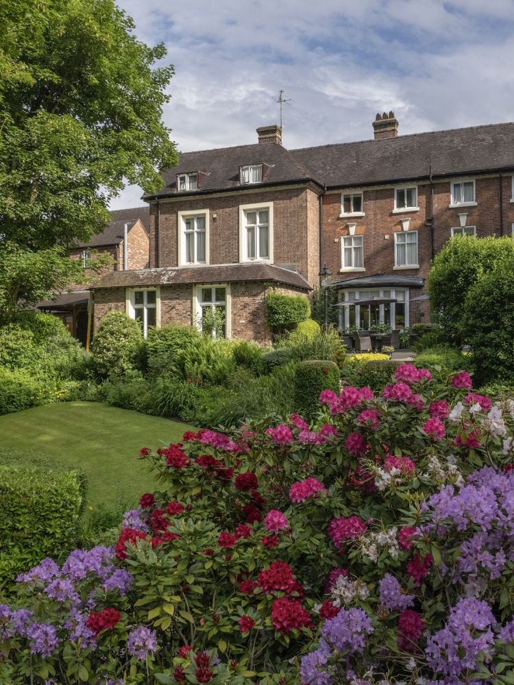 a view of a country hotel with its gardens in bloom in ironbridge in shropshire