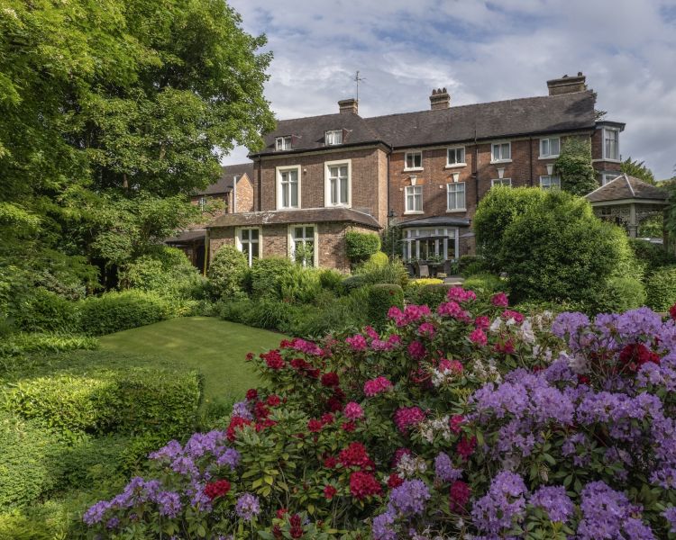 a view of a country hotel with its gardens in bloom in ironbridge in shropshire