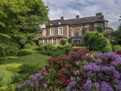 a view of a country hotel with its gardens in bloom in ironbridge in shropshire