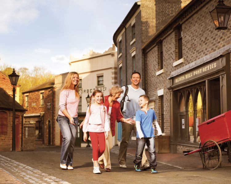 a family walking through blists hill victorian town, a local attraction to ironbridge in shropshire