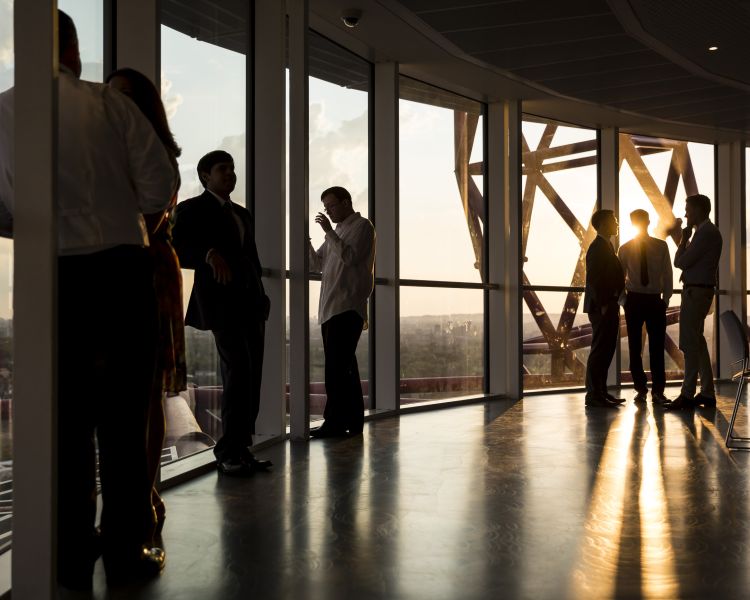 people looking out over london from the arcelormittal orbit 360 viewing platform at sunset