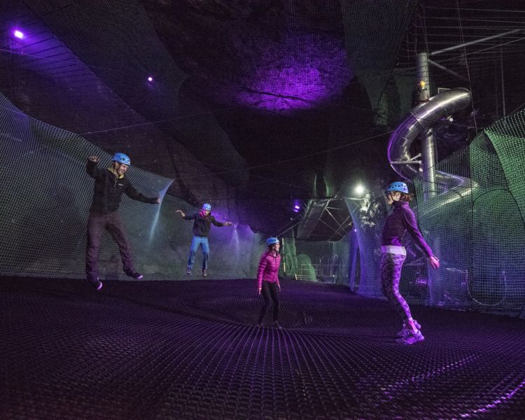 people bouncing on the trampolines underground at zip worlds bounce below