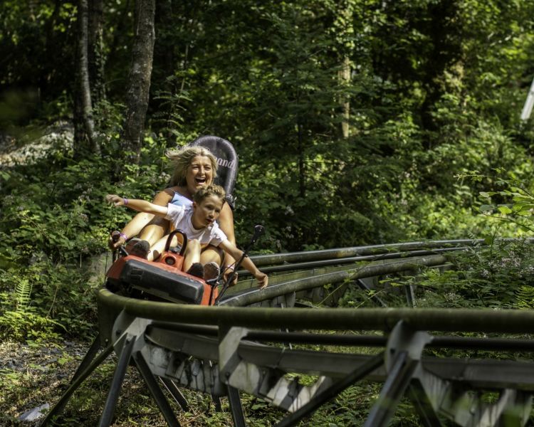 mum and son riding the fforest coaster at zip world in wales