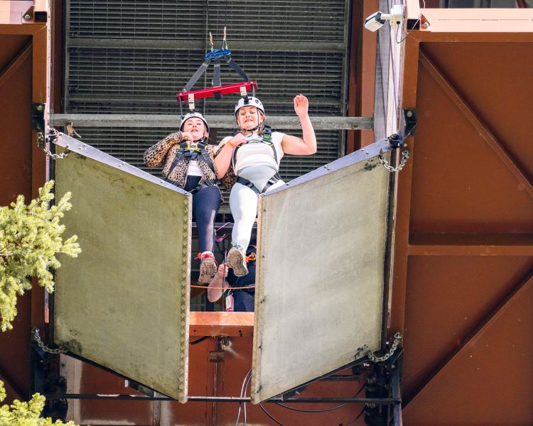 two people falling through the trap door at the top of zip world plummet