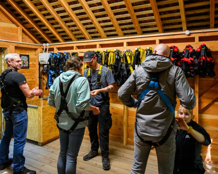 people getting kitted up ready to go on zip world plummet