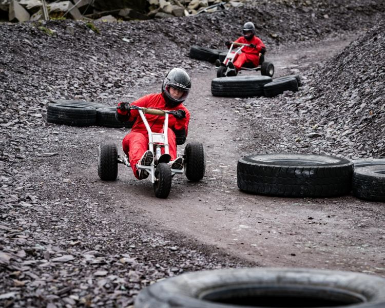 two people navigating around course obstacles on the dirt track at zip world quarry karts