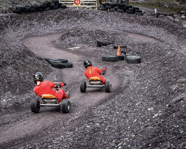 two people on the dirt track at zip world quarry karts