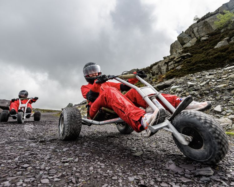 two people on the dirt track at zip world quarry karts