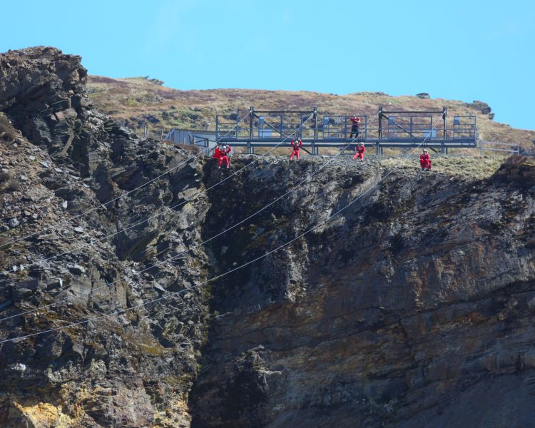 view of people going down the zip lines at zip world titan in wales