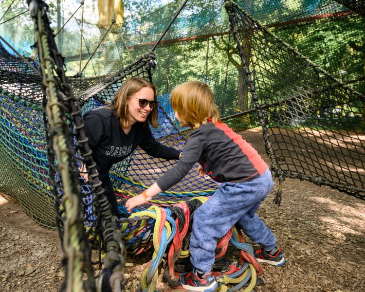 woman and young child on the nets at zip world treetop nets