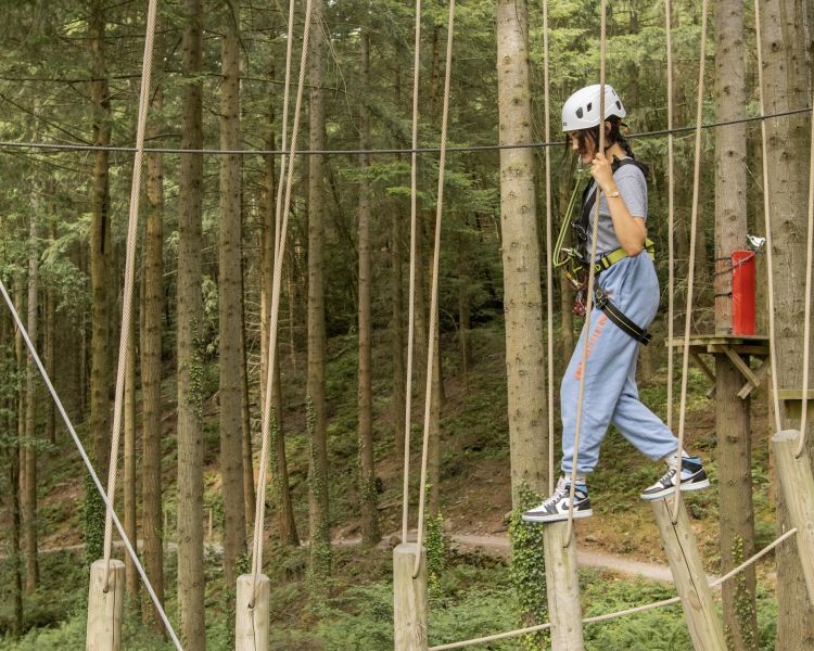young girl making her way along the course at zip world zip safari