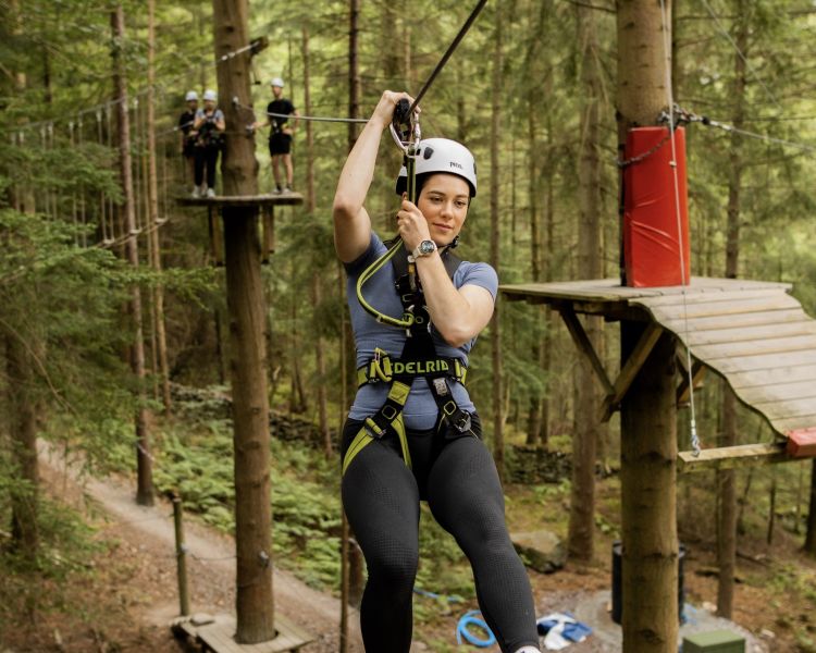woman ziplining along the course at zip world zip safari
