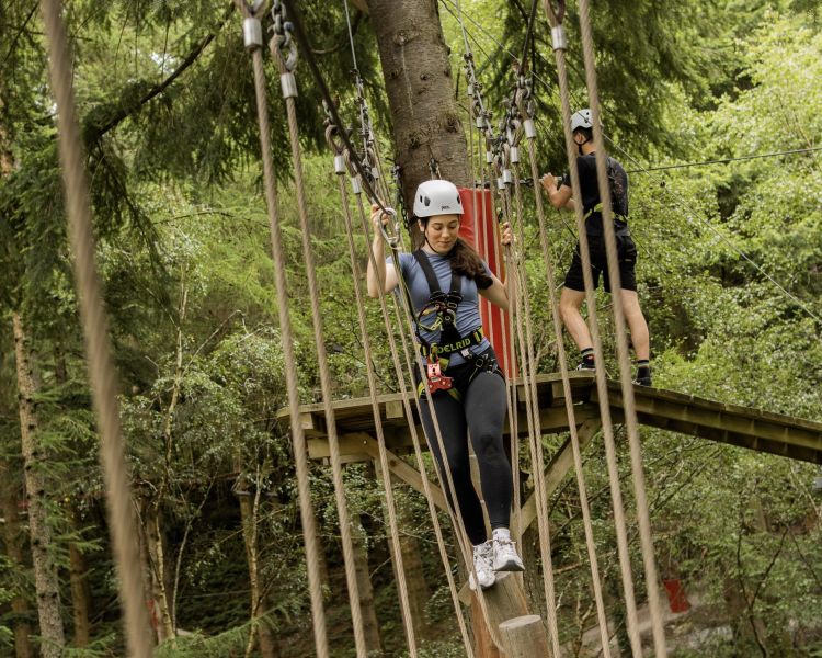 woman making her way along the course at zip world zip safari