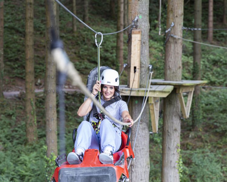 young woman making her way along the course at zip world zip safari