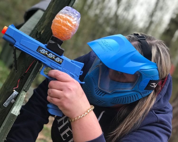 Adult shooting a gel blaster