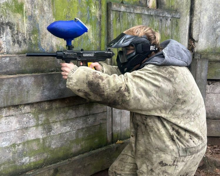 Young lad shooting a paintball gun