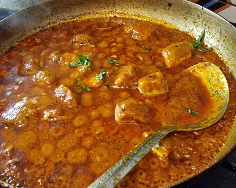 Indian food being cooked on the hob on the cookery lesson