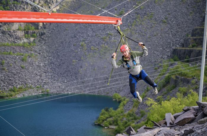 man on the zip world aero explorer overlooking the quarry and lake