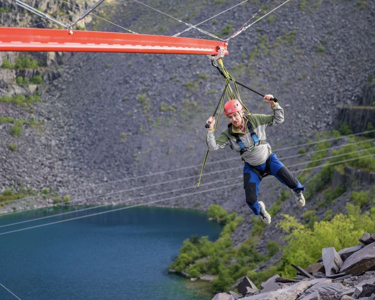 man on the zip world aero explorer overlooking the quarry and lake