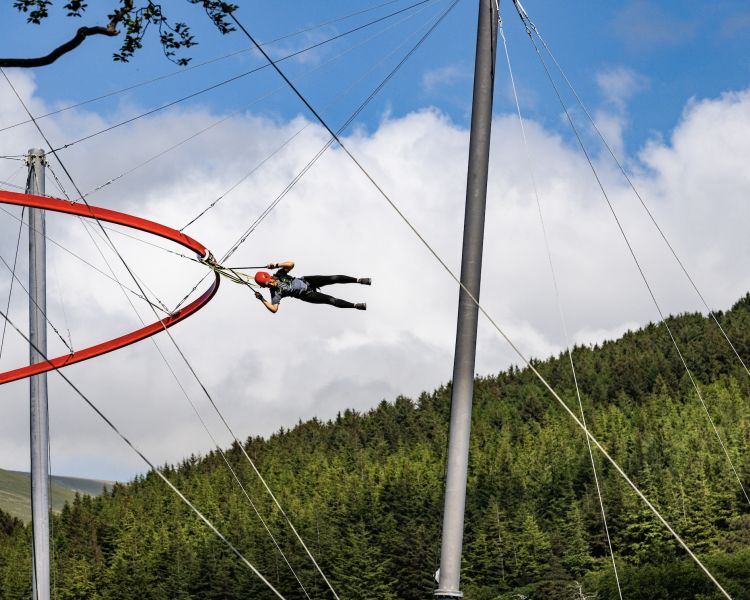 person flying around the zip world aero explorer overlooking woodland