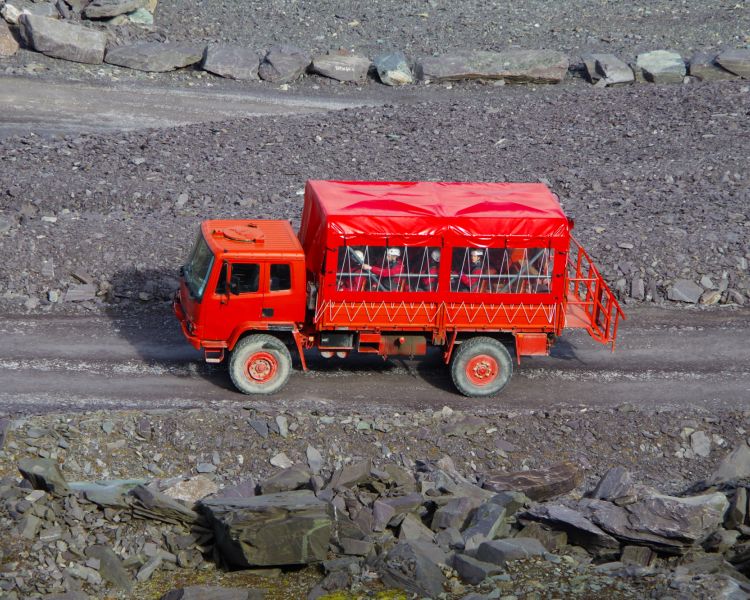 view of the red ex army truck used on the penrnyn slate quarry tour which you can do with zip world