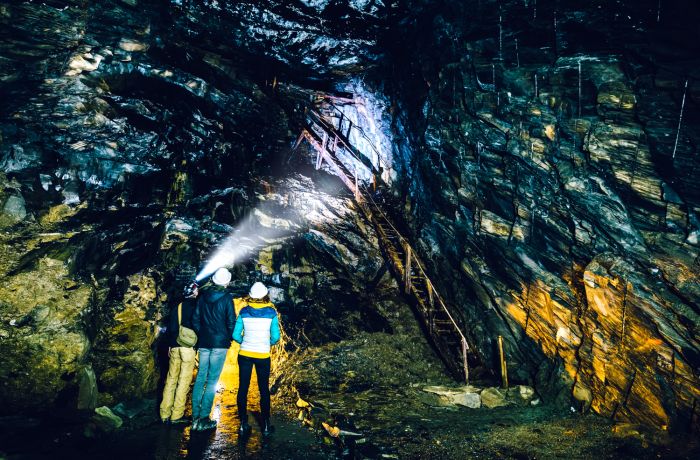 People exploring the underground slate mine at zip world llechwedd in wales