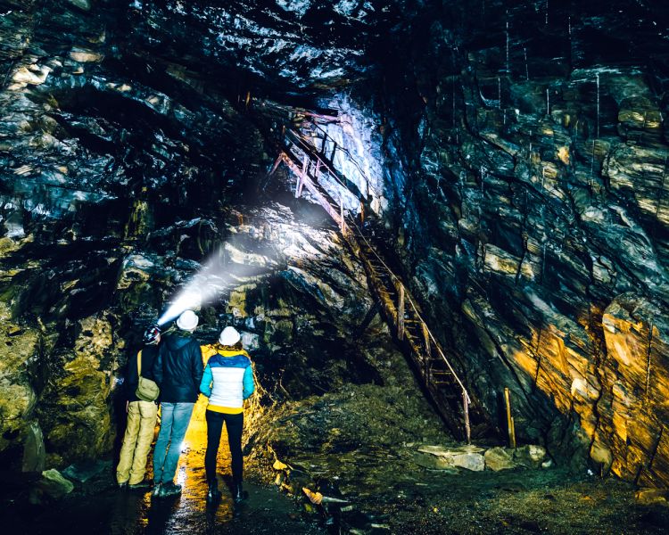 People exploring the underground slate mine at zip world llechwedd in wales