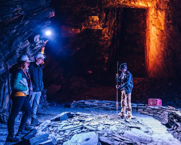 people learning about the old slate mine on the zip world llechwedd deep mine tour