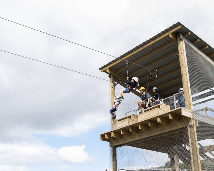 tow young children setting off on the zip line at zip world tower flyer at the tower colliery location