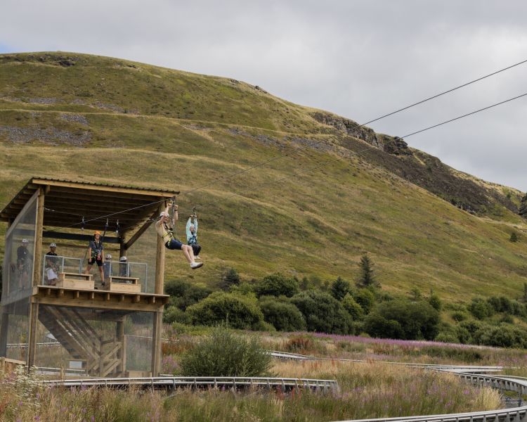 person on the zip line with mountains in background at zip world tower flyer at the tower colliery location