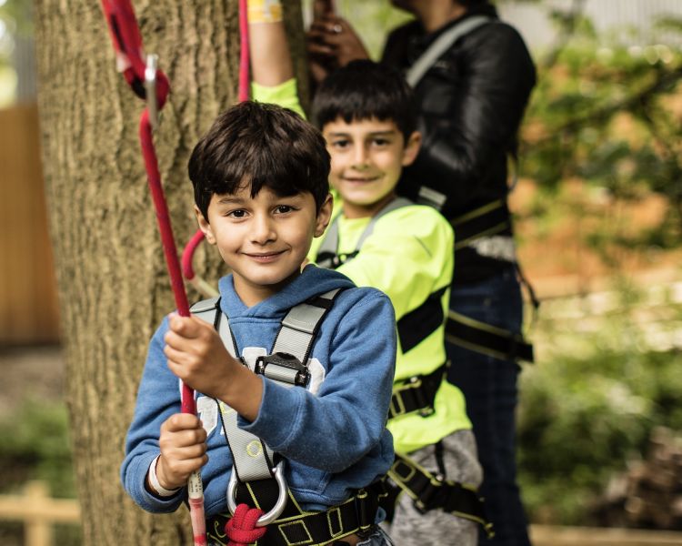 to boys waiting to go on the next obstacle on the zip world mini trek manchester course
