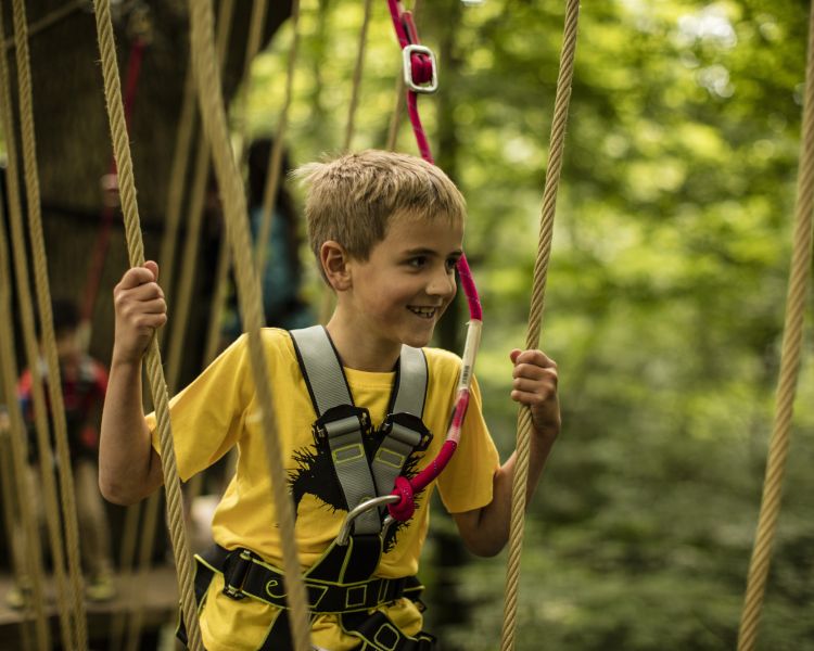 boy crossing an obstacle on the zip world mini trek manchester course
