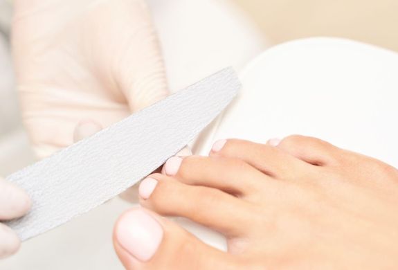 A pedicure treatment on a foot