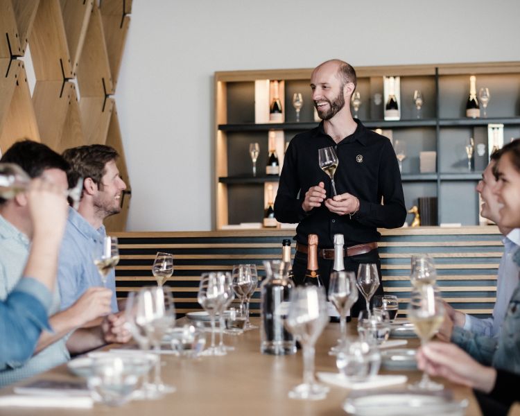 group of people enjoying a wine tasting on a tour of gusbourne estate