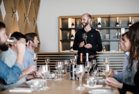 group of people enjoying a wine tasting on a tour of gusbourne estate