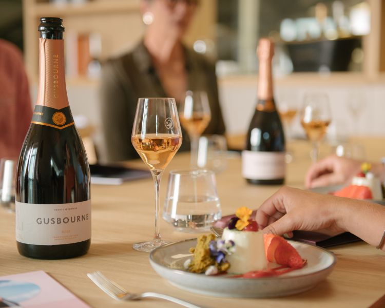 a close up of a glass of rose with a panna cotta dessert as part of a lunch with tour of the gusbourne estate