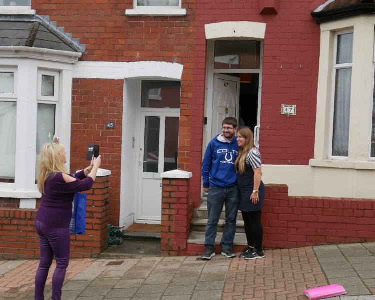 couple having their photo taken outside stacey's house on the official gavin and stacey tour experience
