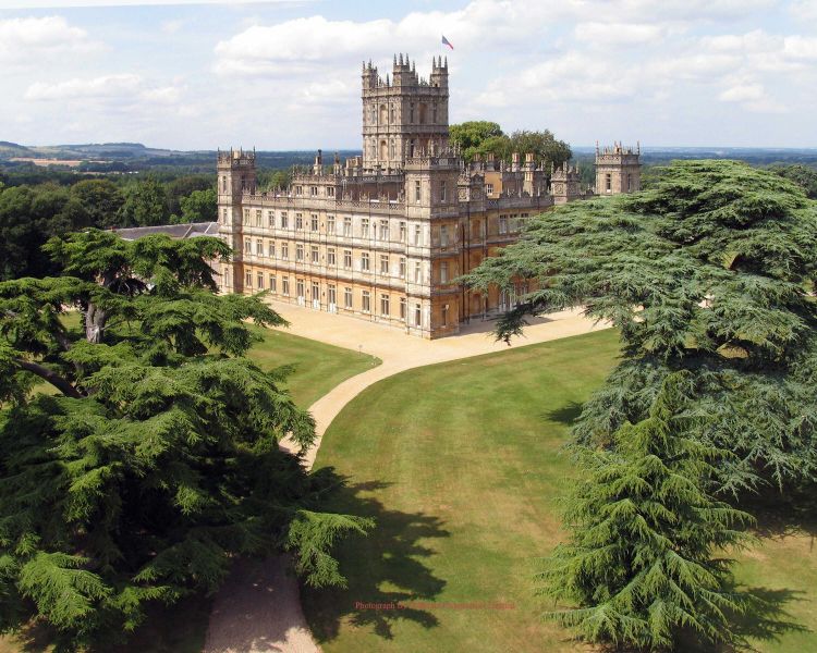the view of highclere castle which was used as the setting for downtown abbey seen on a guided coach tour of downtown abbey