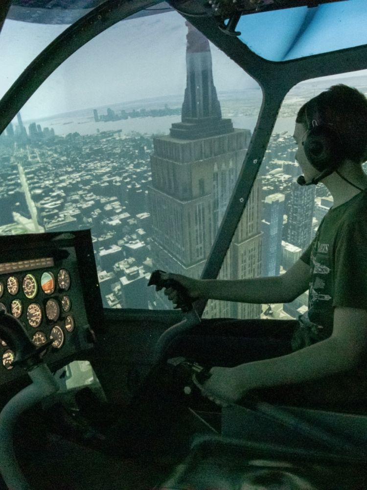 Young boy in helicopter simulator in night mode