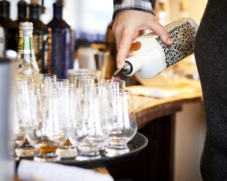 bottle of gin being poured to sample on a distillery tour with forest distillery in cheshire