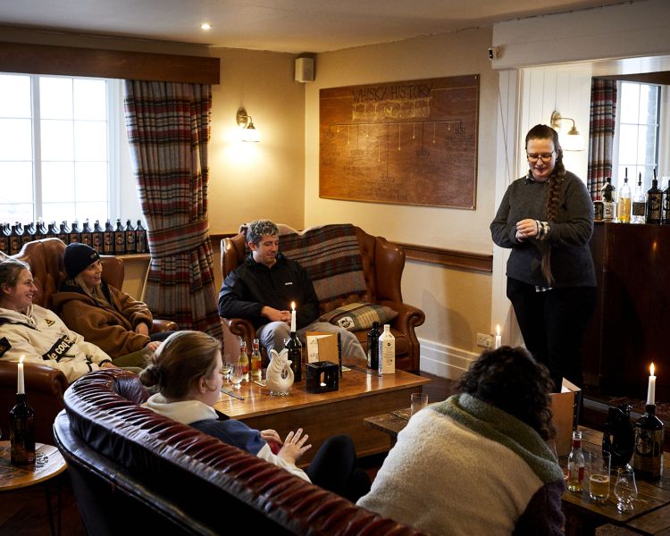 people sitting listening to then guide on a distillery tour with forest distillery in cheshire