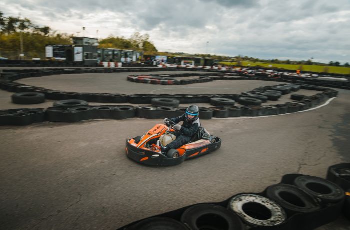 person racing in a go-kart around a track at midland karting