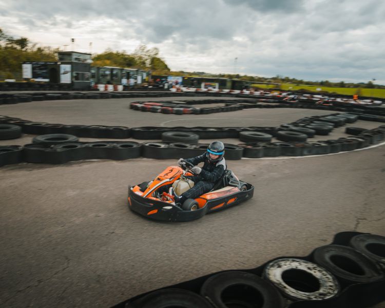 person racing in a go-kart around a track at midland karting