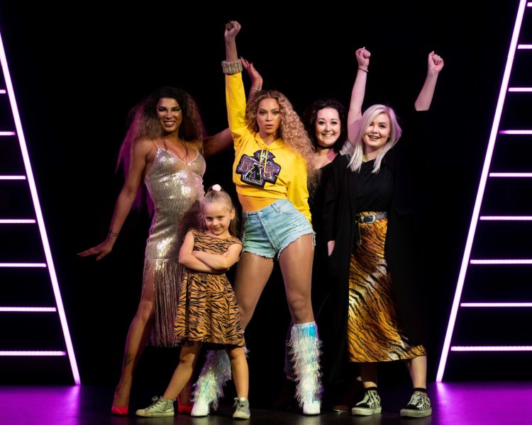 group of girls posing with the figure of Beyoncé at madame tussauds in london