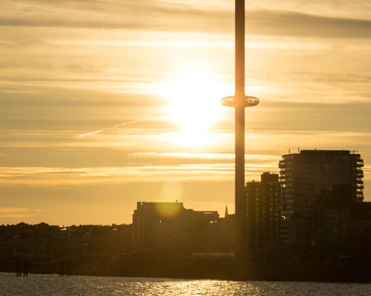 view of the i360 viewing platform in brighton with the sun behind it