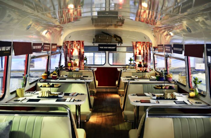 the interior of the red bus bistro set up for afternoon tea