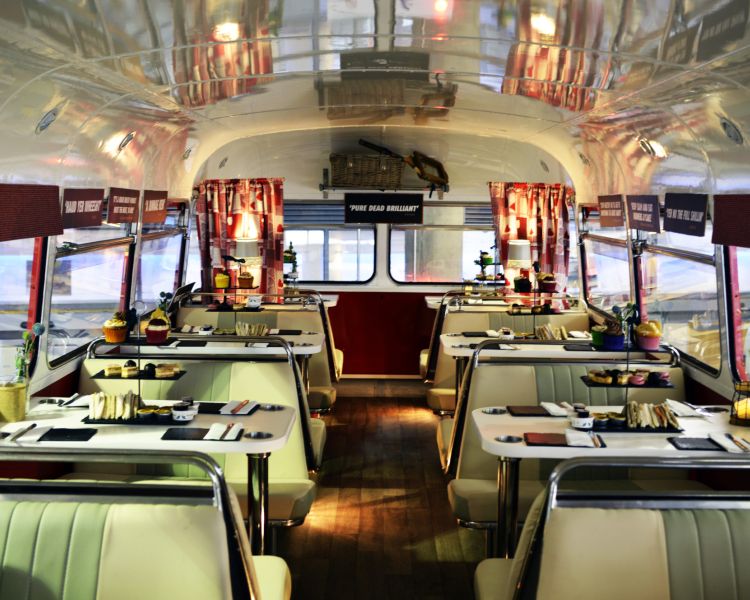 the interior of the red bus bistro set up for afternoon tea