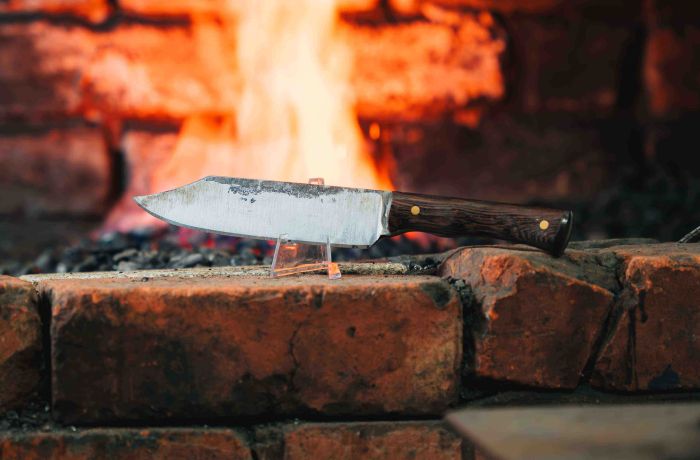 a knife in front of a fire made on a knife making and handling experience